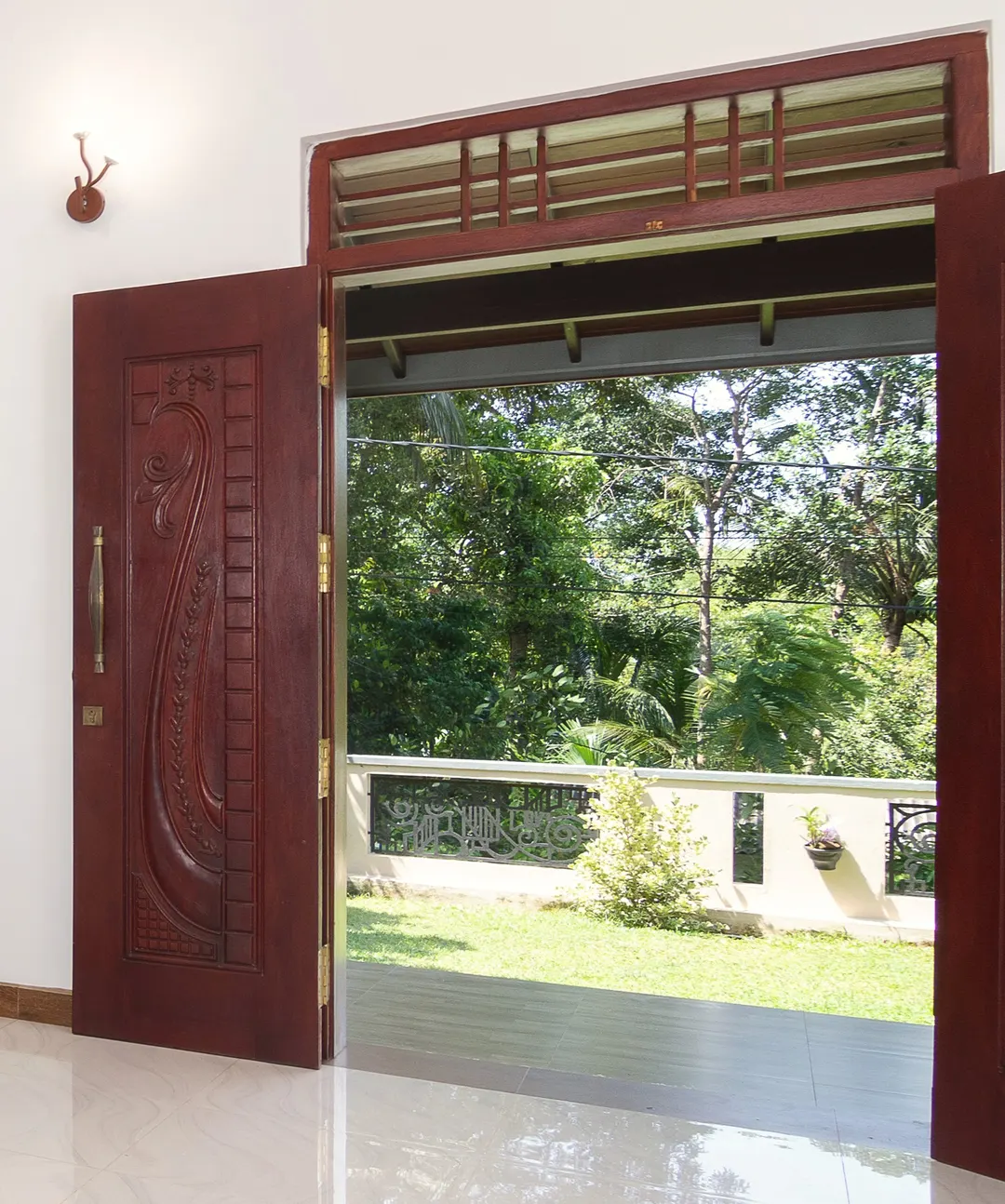 The carved front door, open to the garden