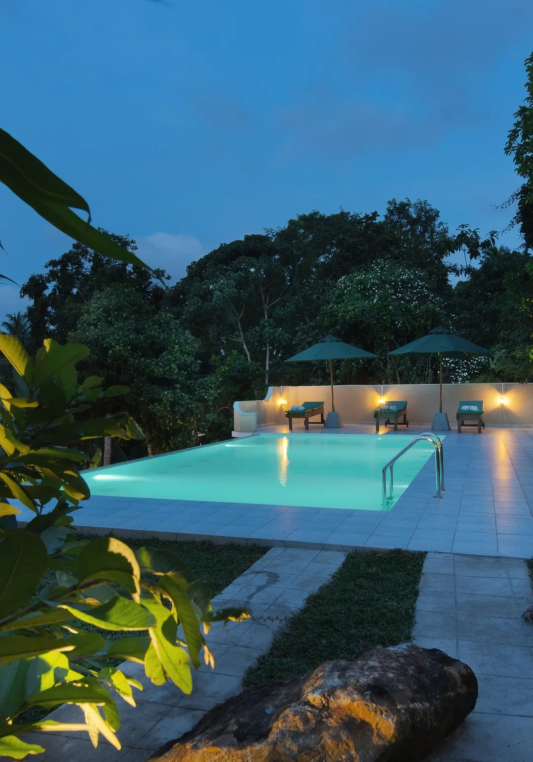 The pool at dusk, seen from the garden path