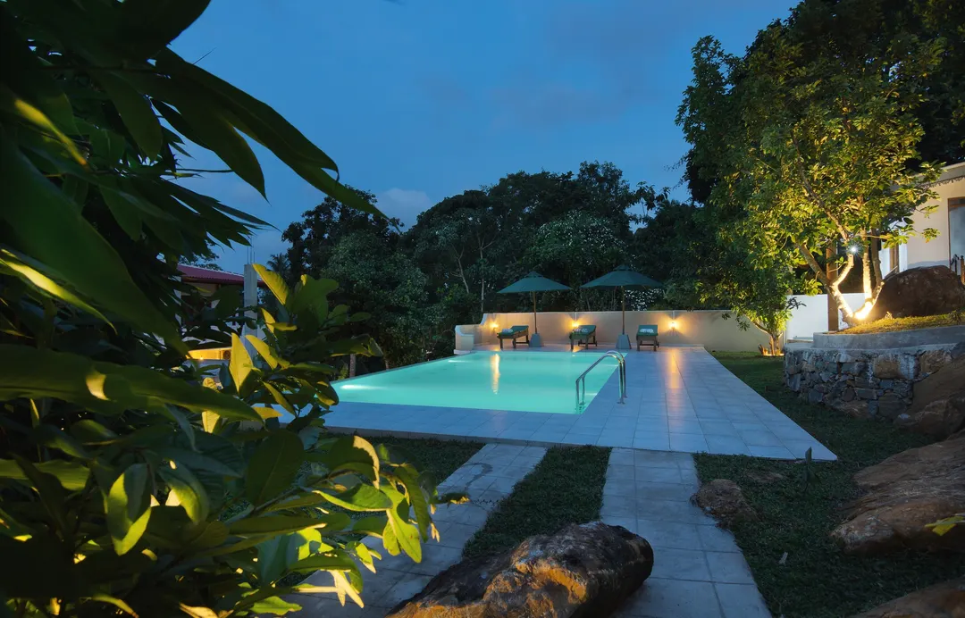 The pool at dusk, seen from the garden path