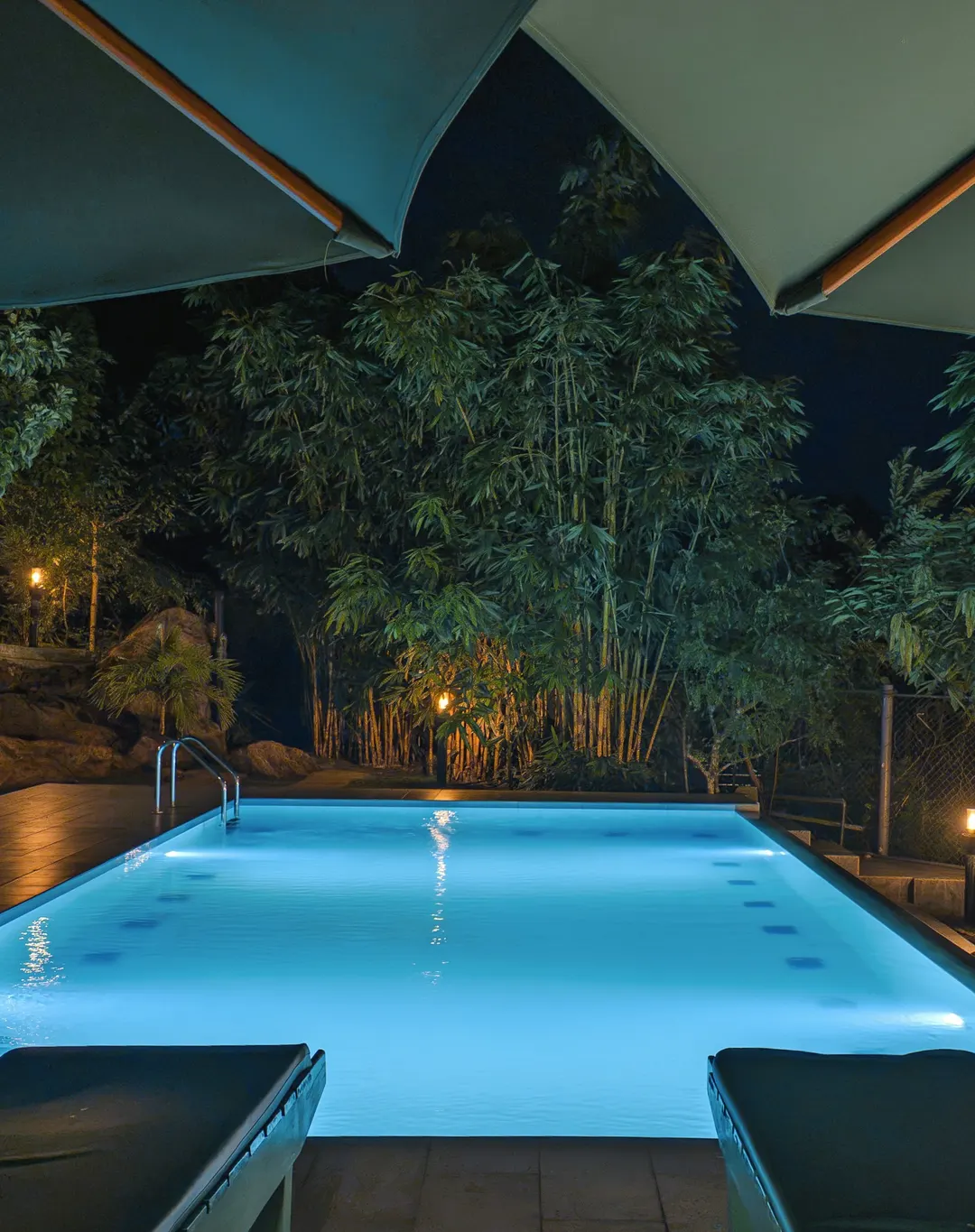 The pool at night under the umbrellas