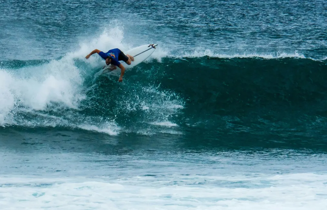 A surfer turning on a wave at Hikkaduwa