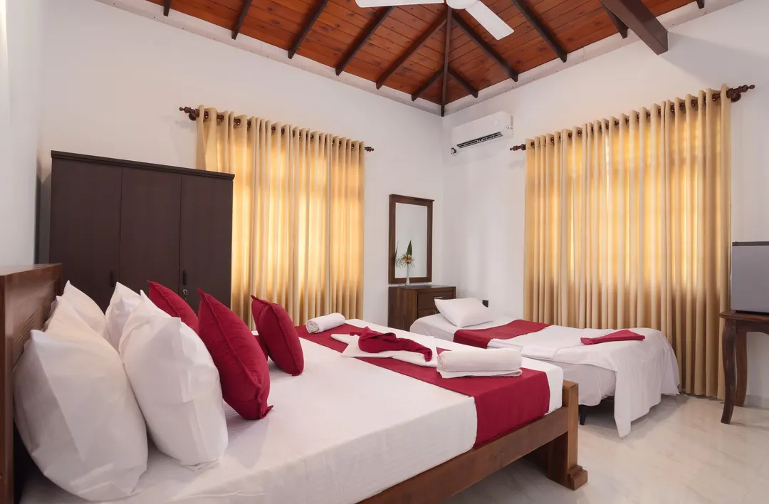 A Deluxe Triple Room with a king bed, and the sofa bed opened out as a third bed