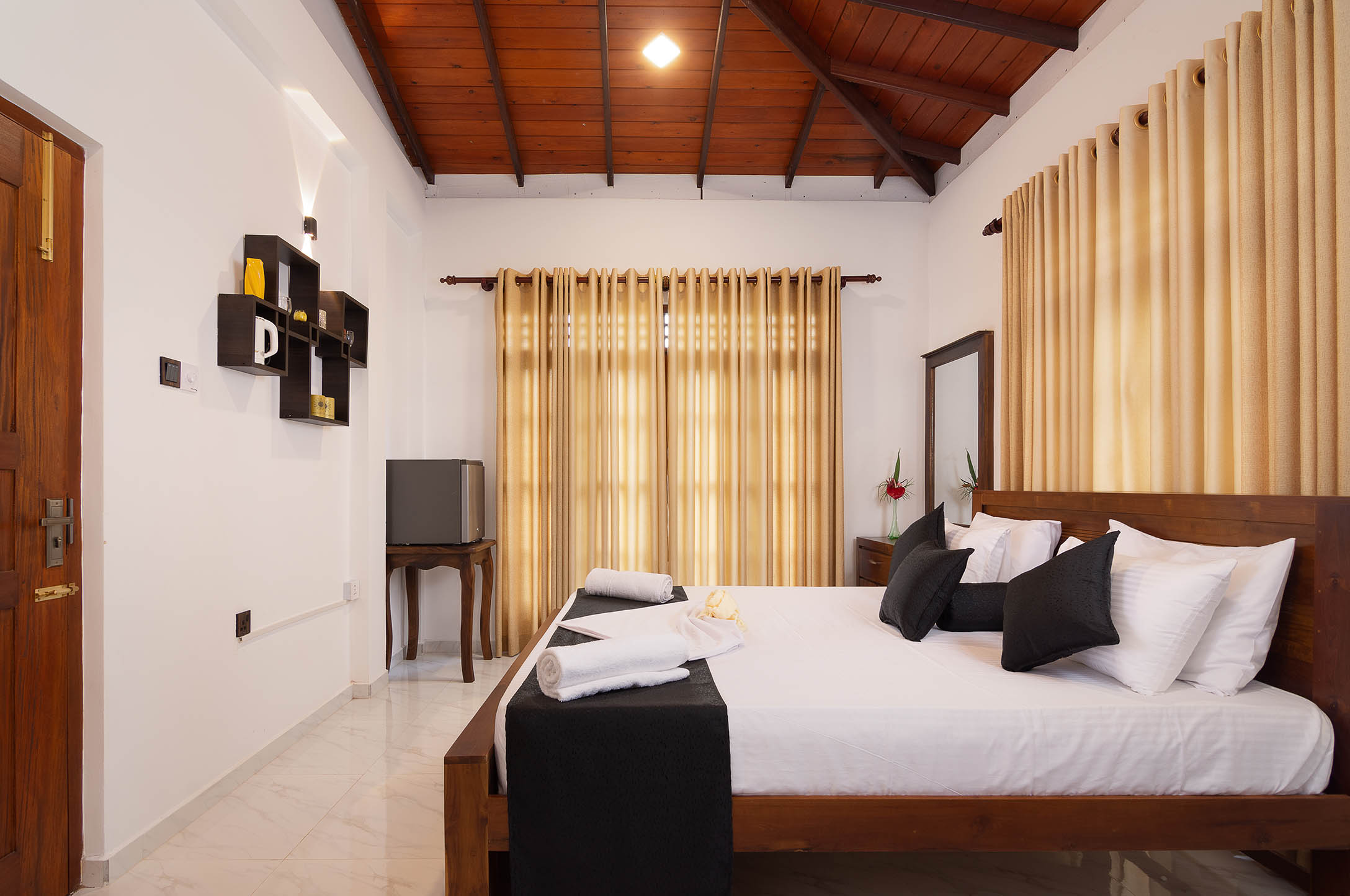 Relax in the luxurious bedroom at Tranquil Escape villa in Hikkaduwa, Sri Lanka. Enjoy a comfortable king-size bed, air conditioning, and a modern, stylish decor