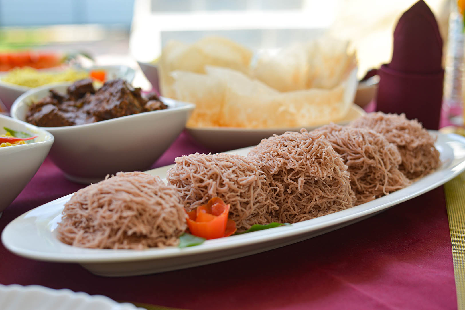 Delicious Sri Lankan string hoppers, a traditional breakfast dish made with steamed rice flour. Served with various curries and condiments at Tranquil Escape villa in Hikkaduwa