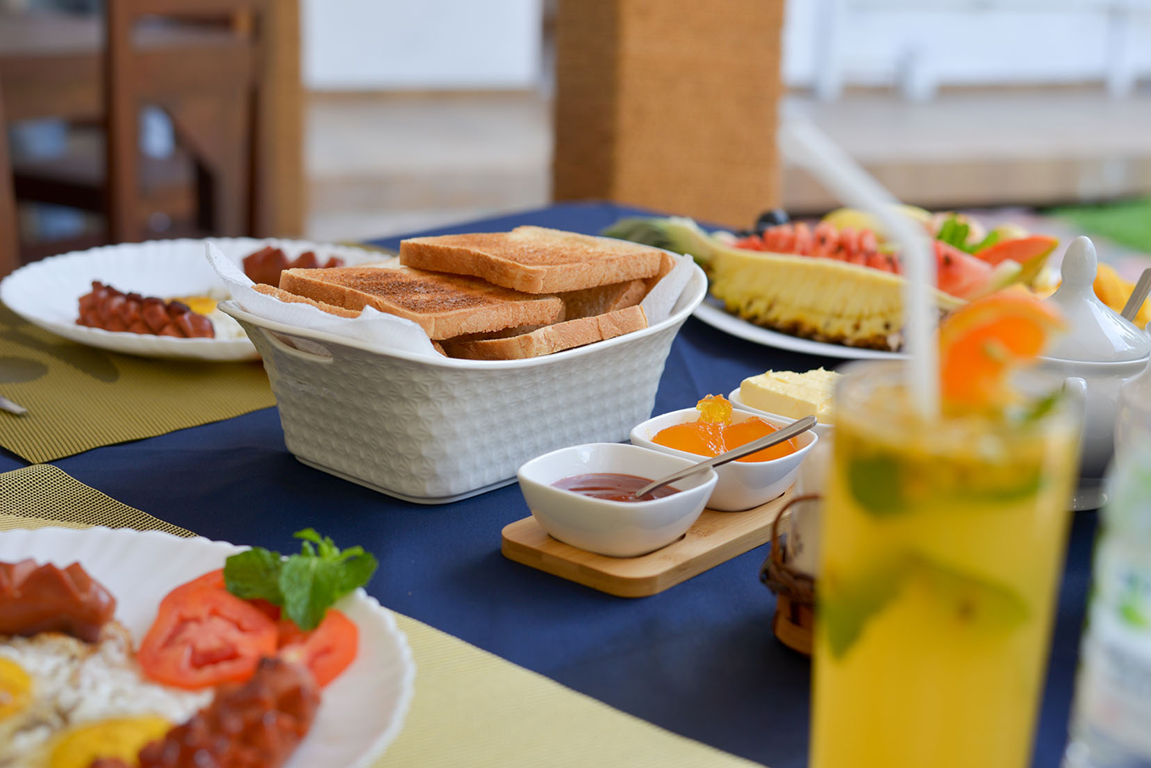 Enjoy a delicious continental breakfast at Tranquil Escape villa in Hikkaduwa, Sri Lanka. Freshly baked toast, sausages, eggs, fruits, and refreshing beverages served on the table