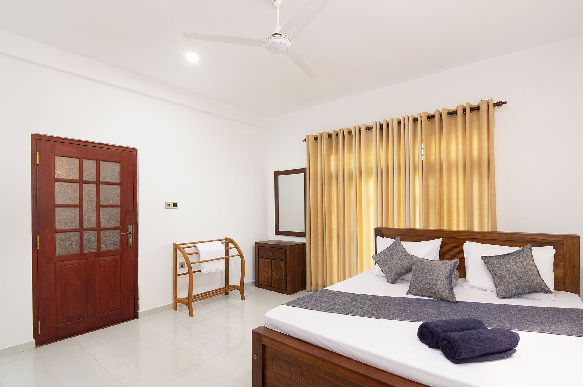 Spacious and modern bedroom at Tranquil Escape villa in Hikkaduwa, Sri Lanka. Featuring a comfortable king-size bed, air conditioning, ample natural light.