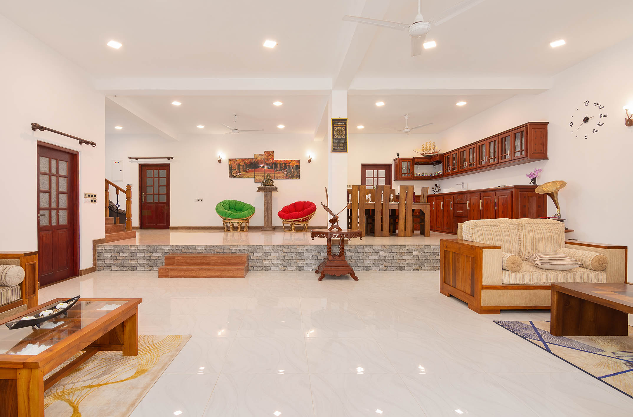 Spacious and elegantly designed living area at Tranquil Escape Villa in Hikkaduwa, Sri Lanka, featuring modern wooden furniture, a cozy seating area, open dining space, and a fully equipped kitchen, ideal for guests seeking comfort and luxury."

Let me know if you'd like any changes!