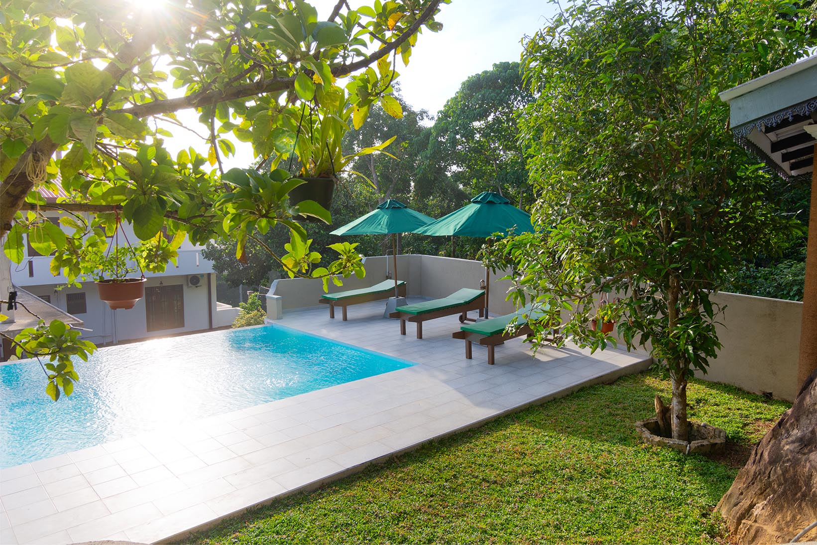 A serene pool in the backyard of Tranquil Escape villa, nestled in Hikkaduwa, surrounded by lush greenery.